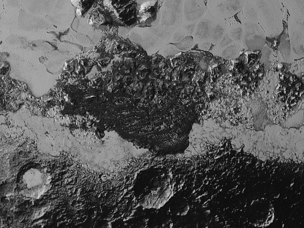This 220-mile (350-kilometer) wide view of Pluto from NASA’s New Horizons spacecraft illustrates the incredible diversity of surface reflectivities and geological landforms on the dwarf planet