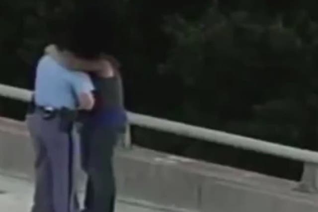 North Carolina police officer talks man off edge of bridge, gives him a hug