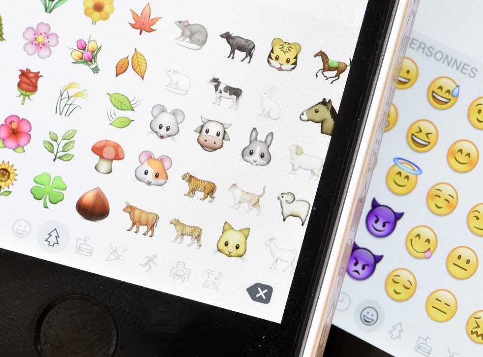 A picture shows emoji characters also known as emoticons on the screens of two mobile phones in Paris on August 6, 2015