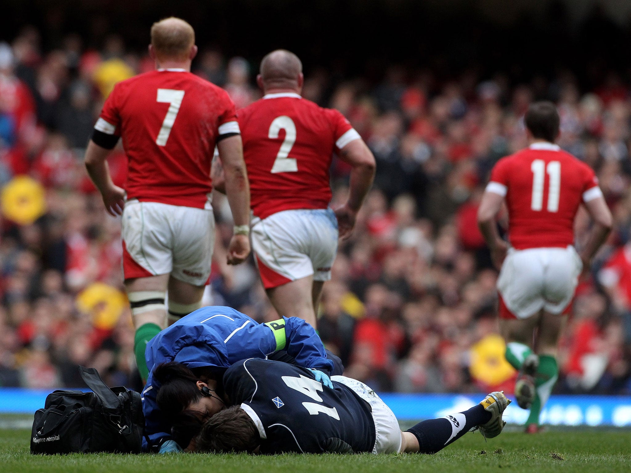 Thom Evans of Scotland receives treatment on the field for a damaged vertebra during a match between Wales and Scotland in, 2010 – he would never play again (Getty)