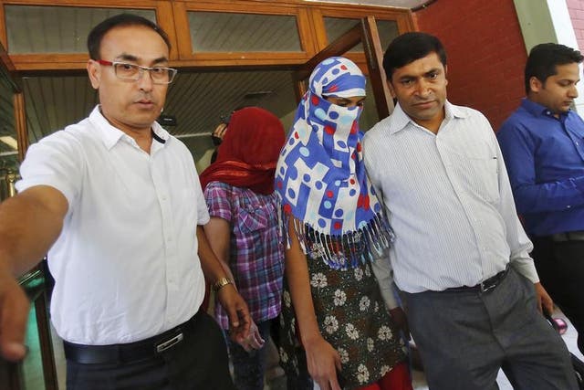 Nepali women who told police they were raped by a Saudi official walk outside Nepal's embassy in New Delhi, India