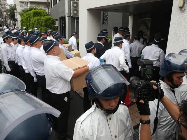 <p>Police officers raid the headquarters of the yakuza crime syndicate in Spetmeber 2021 </p>