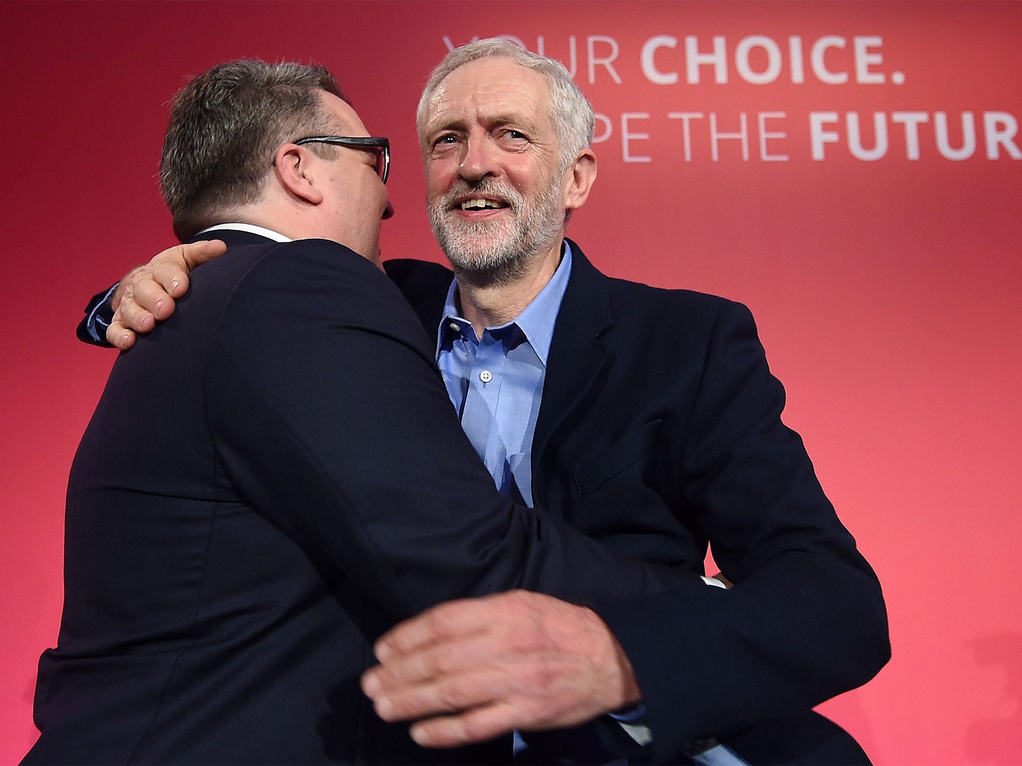 New deputy leader Tom Watson embraces Jeremy Corbyn as the pair celebrate victory