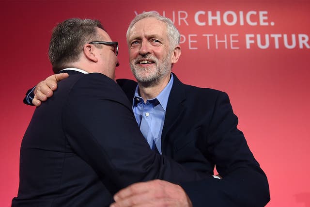 New deputy leader Tom Watson embraces Jeremy Corbyn as the pair celebrate victory