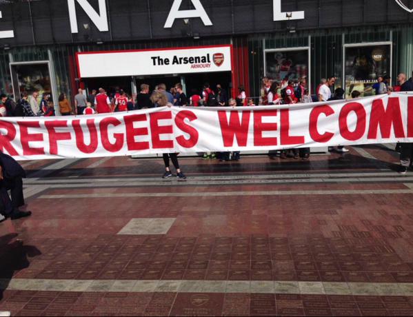 Arsenal fans unveil 'Refugees Welcome' banner outside the Emirates Stadium