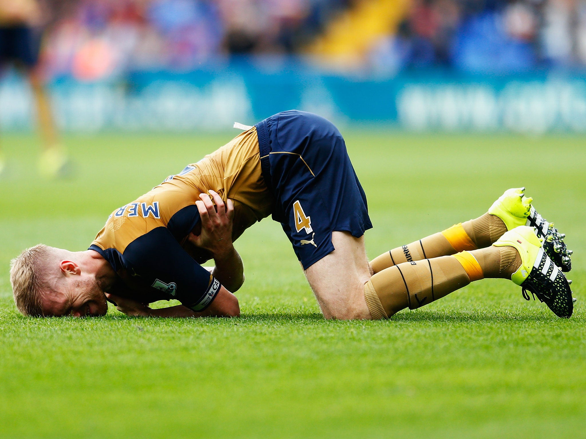 Arsenal defender Per Mertesacker lays injured during the Gunners' Premier League win over Crystal Palace