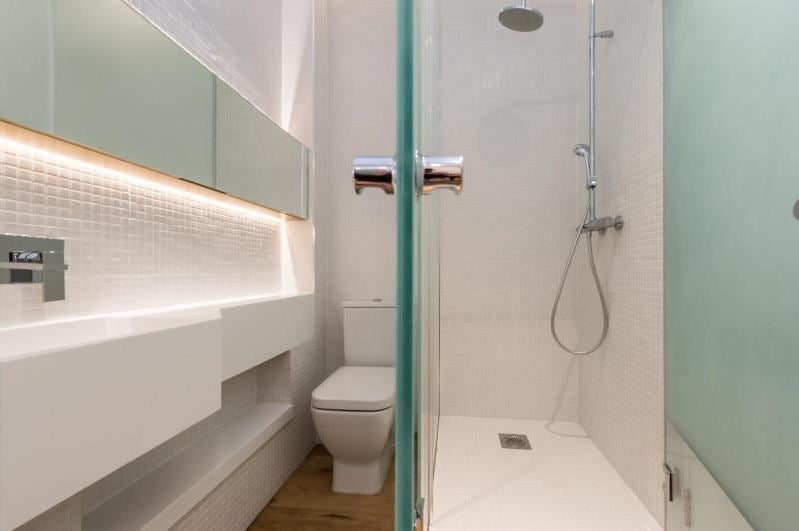 Narrow toilet and shower suite