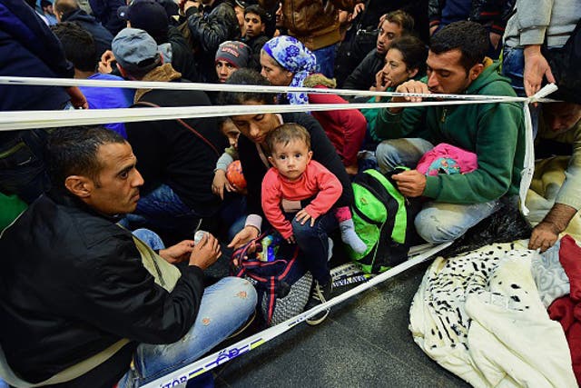 Refugee families wait to be allowed to board trains in Budapest to EU countries including Germany