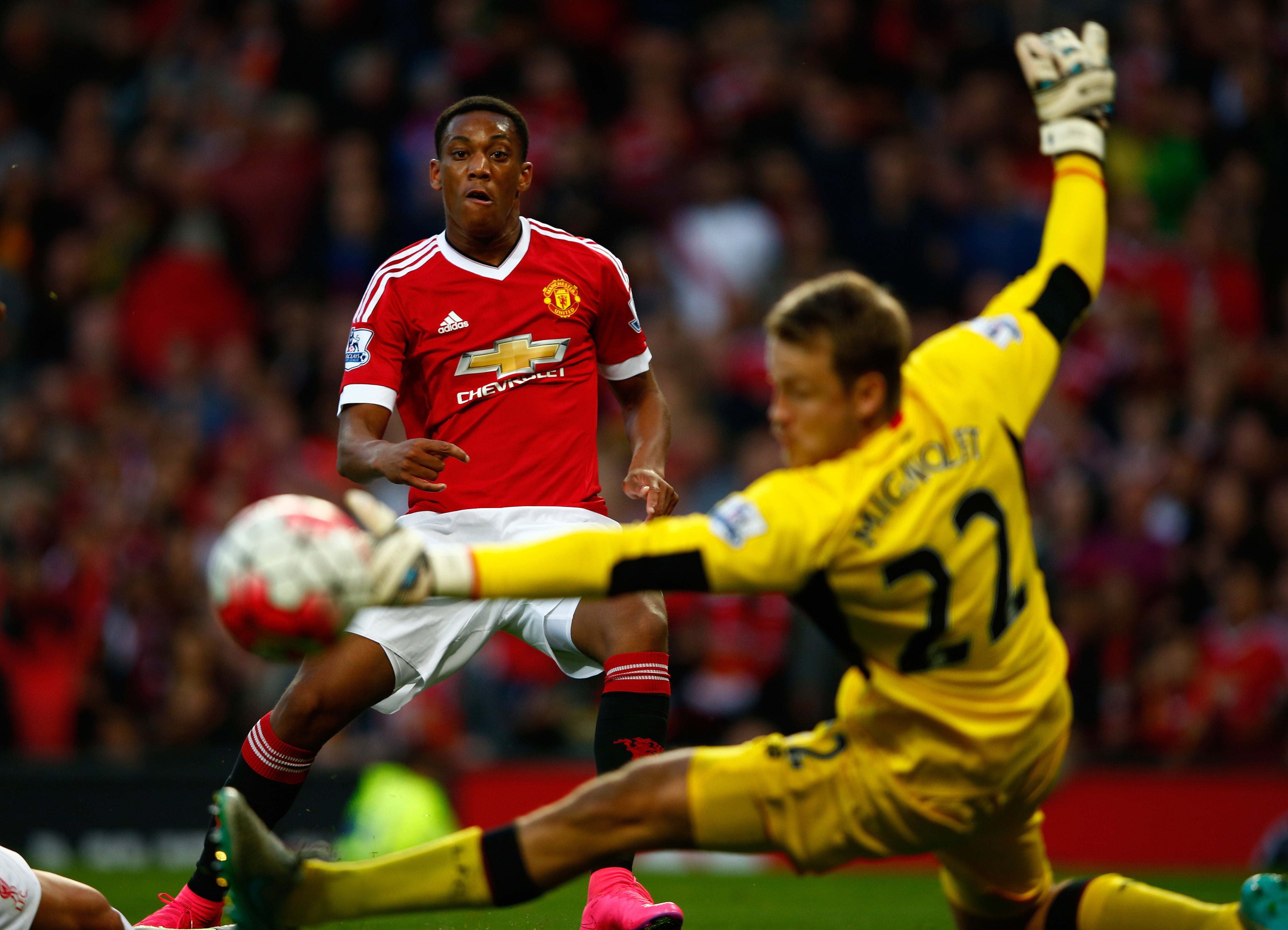 Anthony Martial slots the ball past Simon Mignolet to score his debut goal