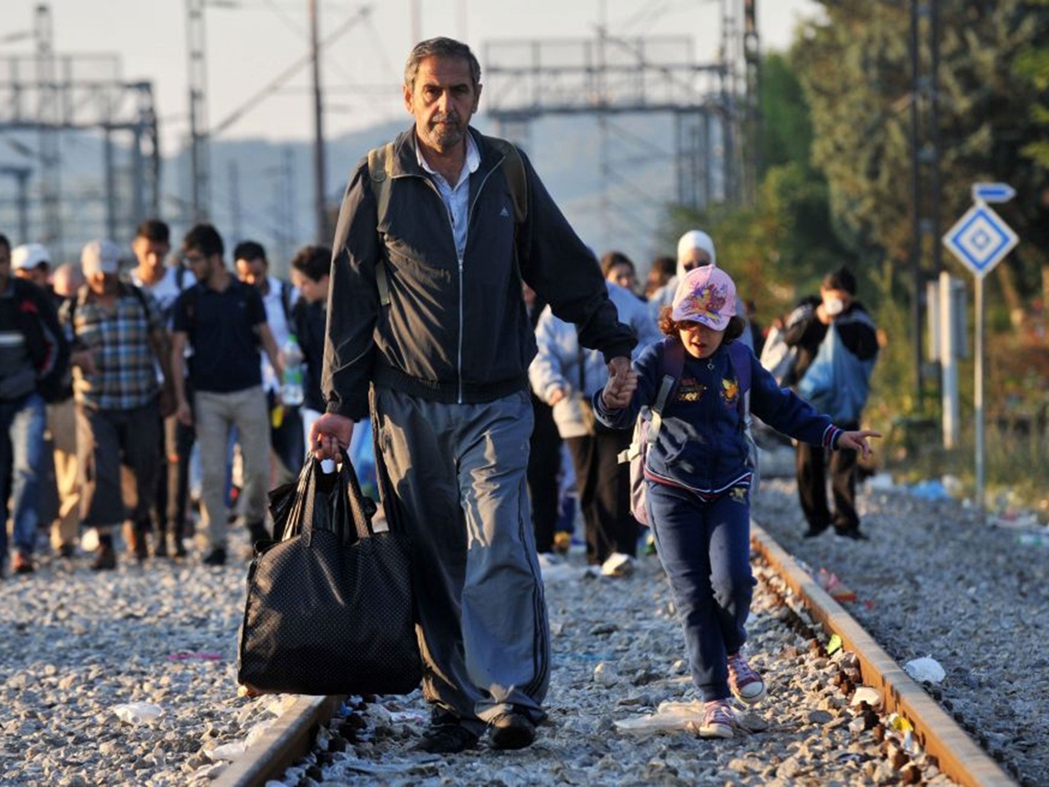 Refugees wait to cross the Greece-Macedonia border near the village of Idomeni, in northern Greece on September 13, 2015