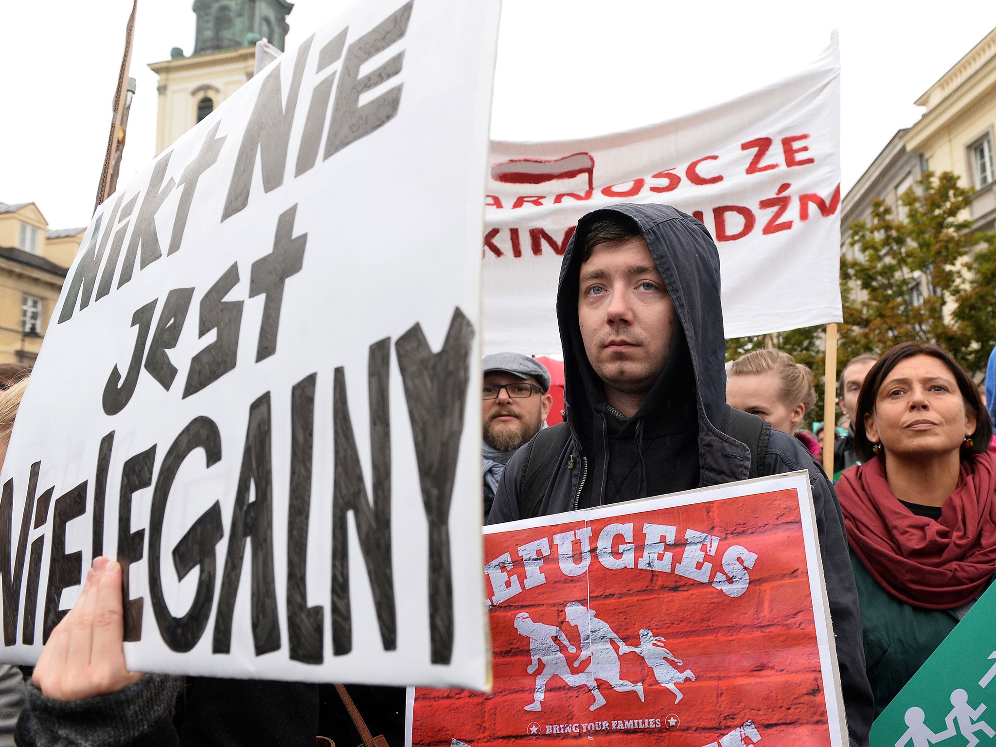 Signs reading 'Refugees welcome' and 'No one is illegal' in Warsaw (Image AFP)