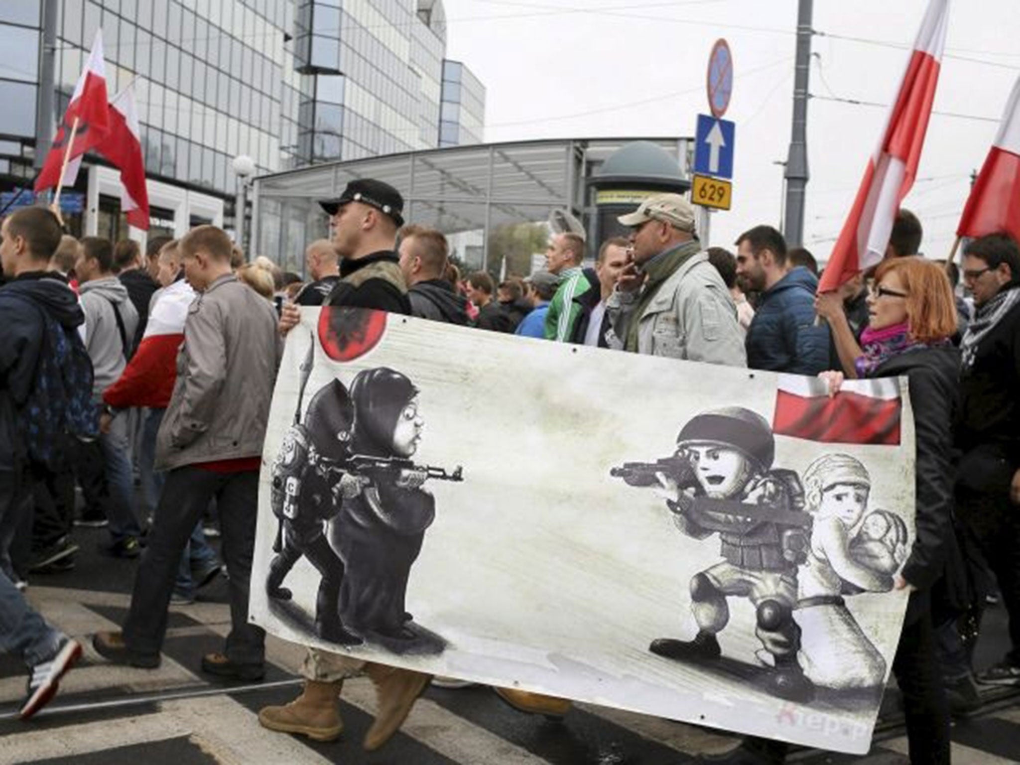 Protesters from far right organisations walk during a protest against refugees in Warsaw, Poland (Image: Reuters)