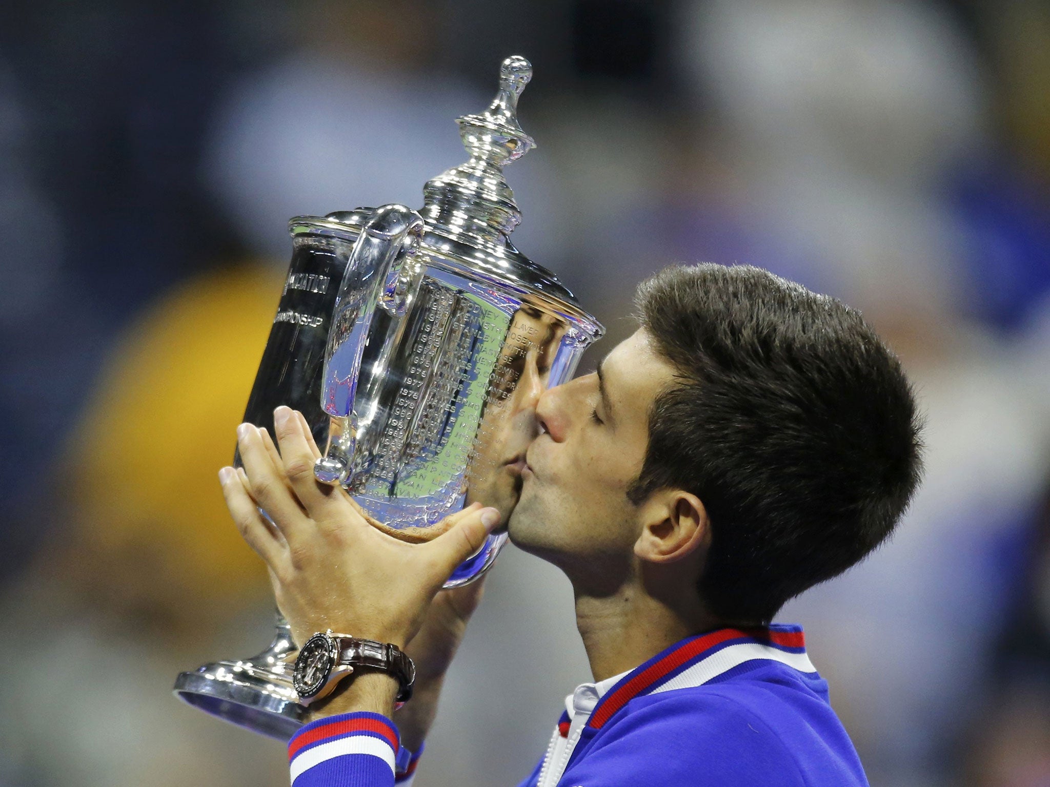 Novak Djokovic kisses the US Open trophy after defeating Roger Federer in their men's singles final match in New York
