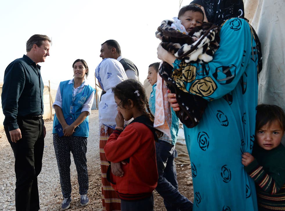David Cameron meets Syrian refugee families at a tented settlement camp in the Bekaa Valley on the Syrian - Lebanese border