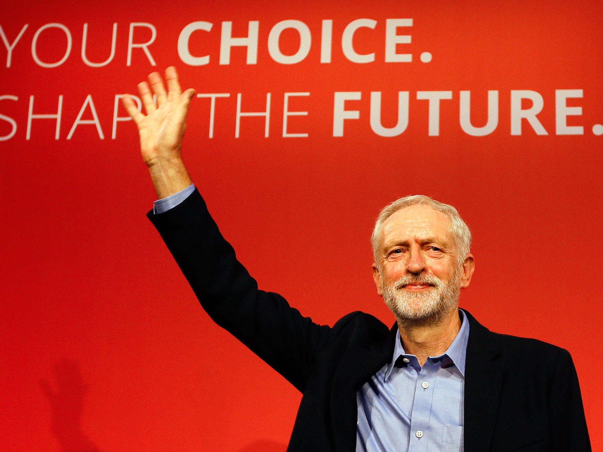 Jeremy Corbyn waves on stage after new is announced as the new leader of The Labour Party during the Labour Party Leadership Conference in London