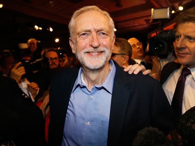 Jeremy Corbyn smiles as he leaves the stage after he is announced as the new leader of The Labour Party during the Labour Party Leadership Conference in London