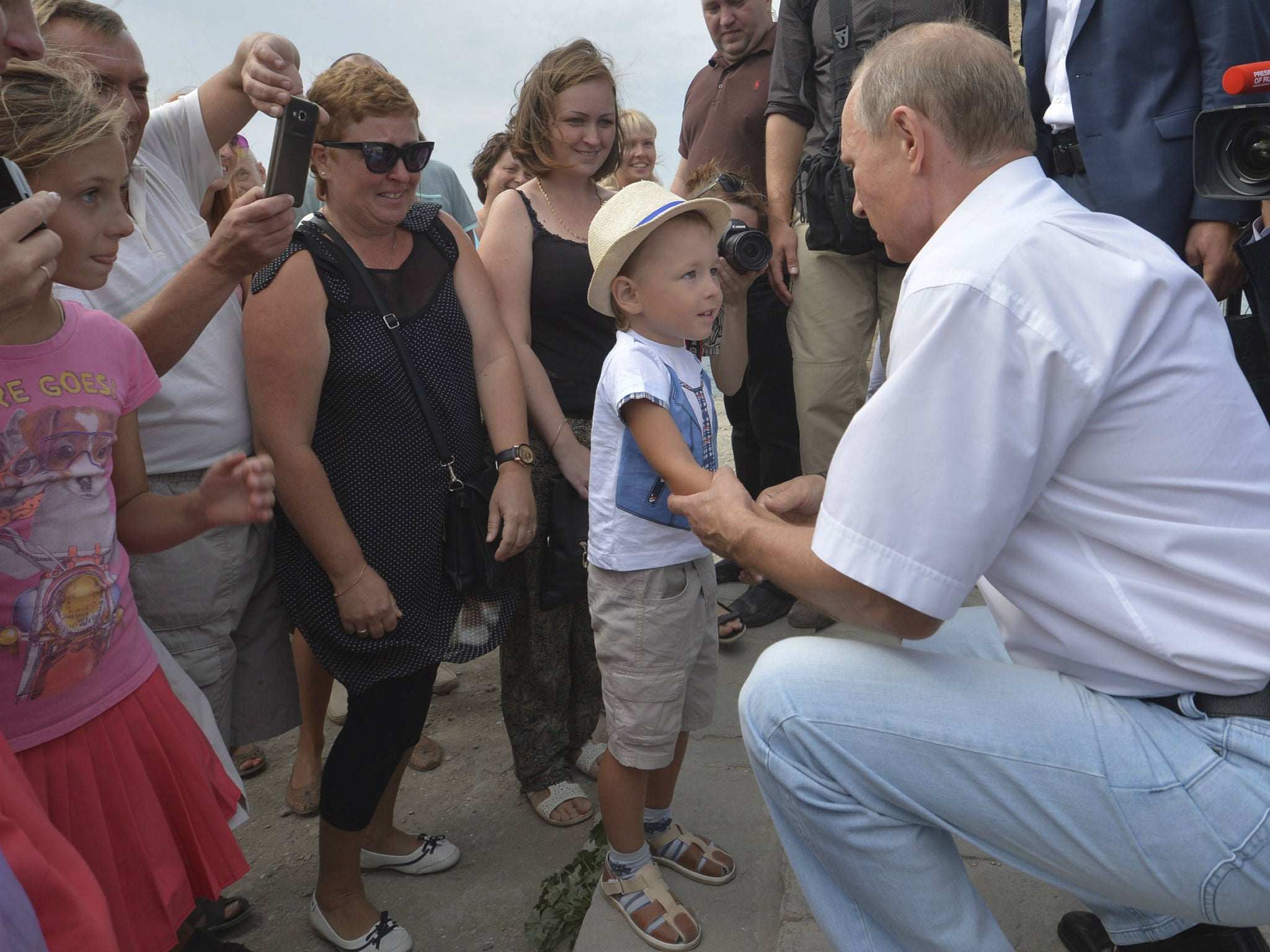 Putin hugs a child