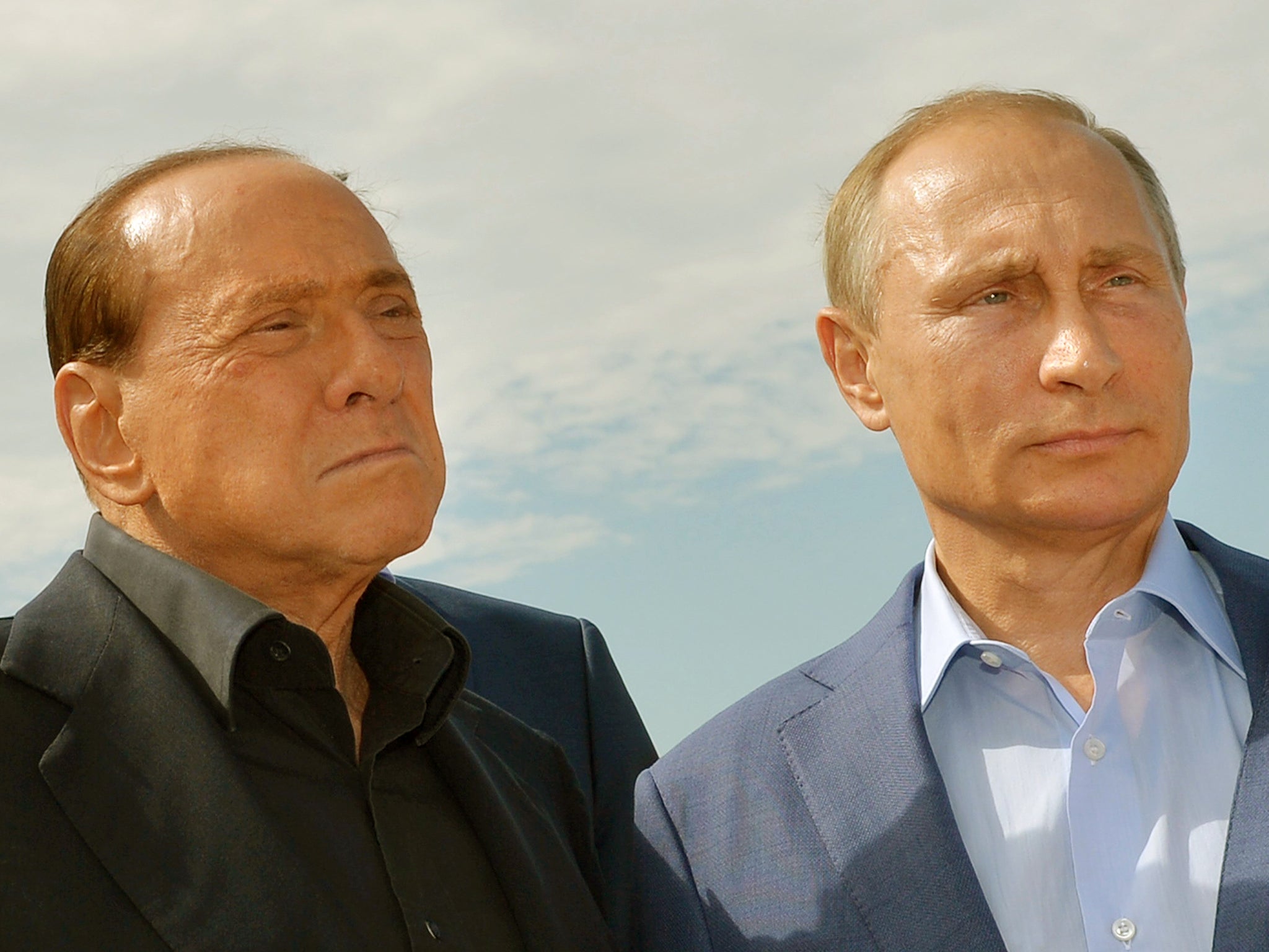 Russian President Vladimir Putin (R) and former Italy's prime minister Silvio Berlusconi visit an Italian war cemetery near the Black Sea port of Sevastopol