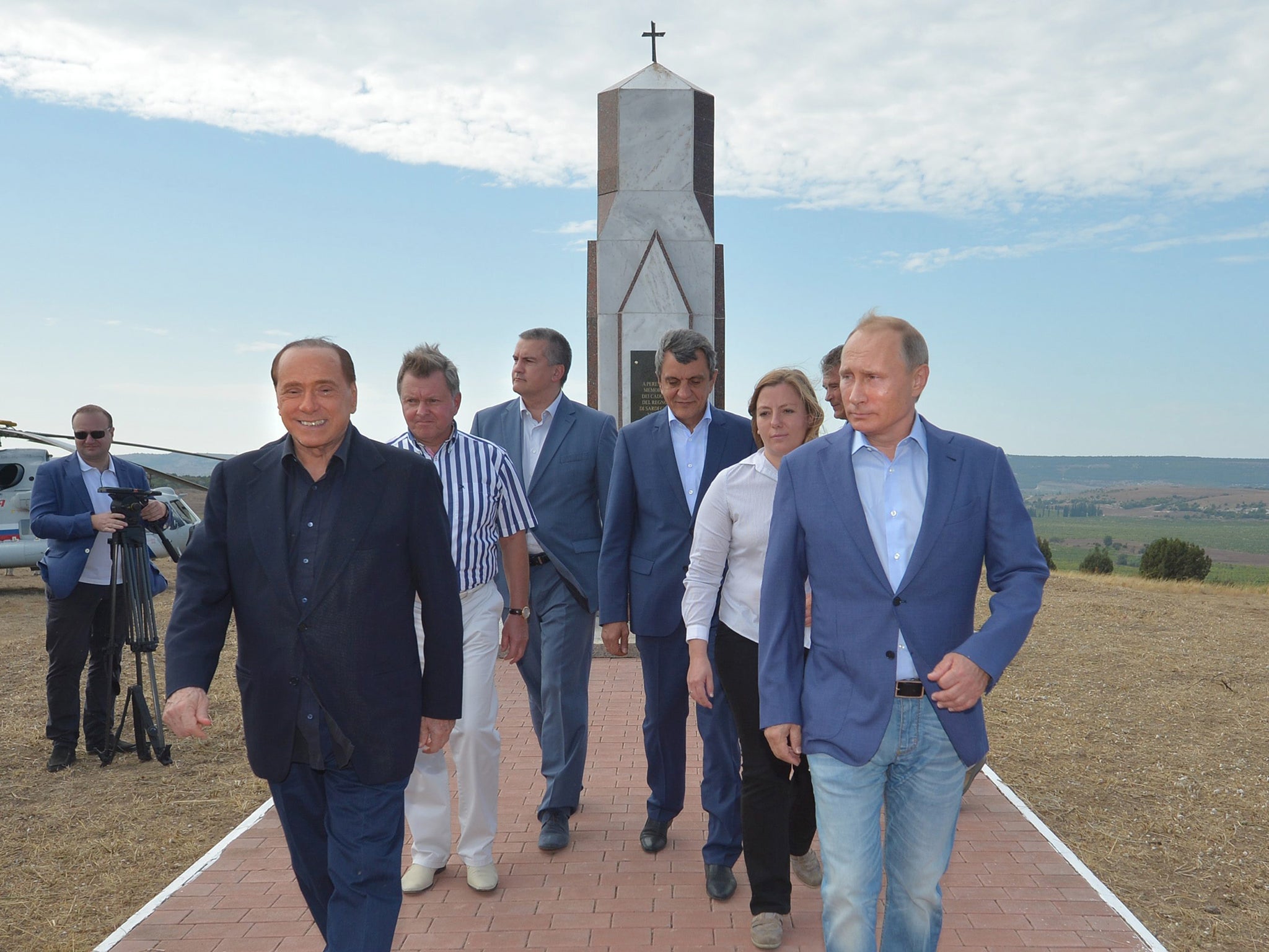 Russian President Vladimir Putin (R) and Italy's former prime minister Silvio Berlusconi (L) visit the memorial to the soldiers from the Kingdom of Sardinia killed in the Crimean War in 19-th century, near Mount Gasfort outside Sevastopol, Crimea