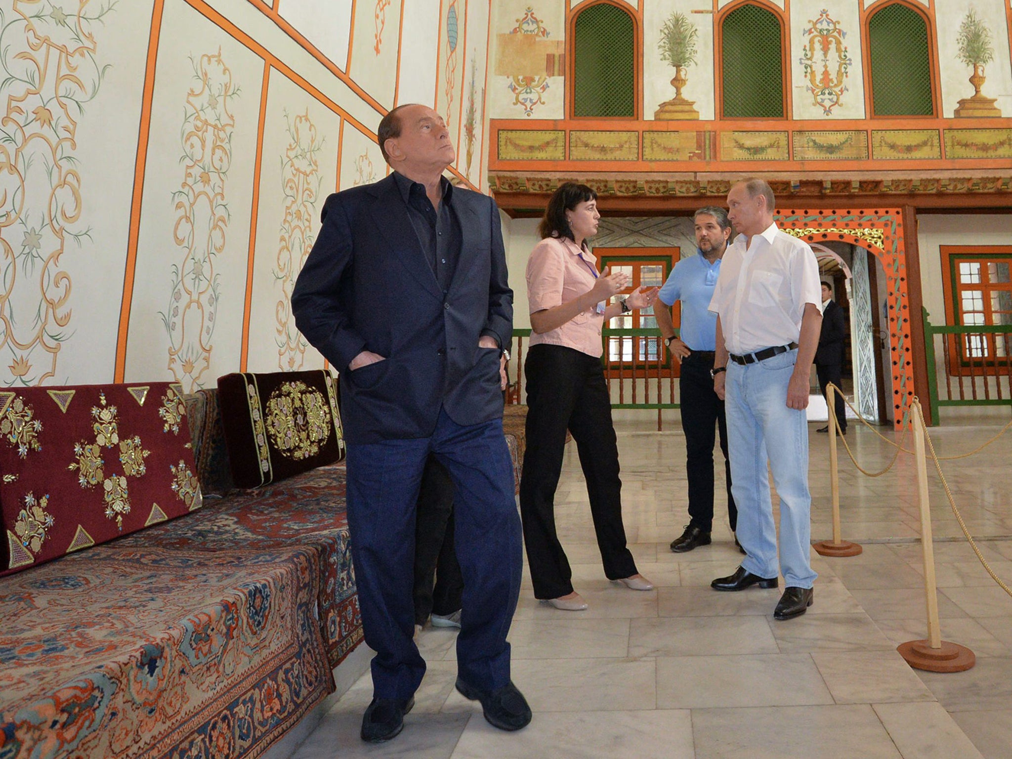 Russian President Vladimir Putin (R) and Italy's former prime minister Silvio Berlusconi (L) examine the Khan's Palace, a former residence of the Crimean Khanate, while visiting the Bakhchisaray Historical and Cultural Preserve in Bakhchisaray, Crimea