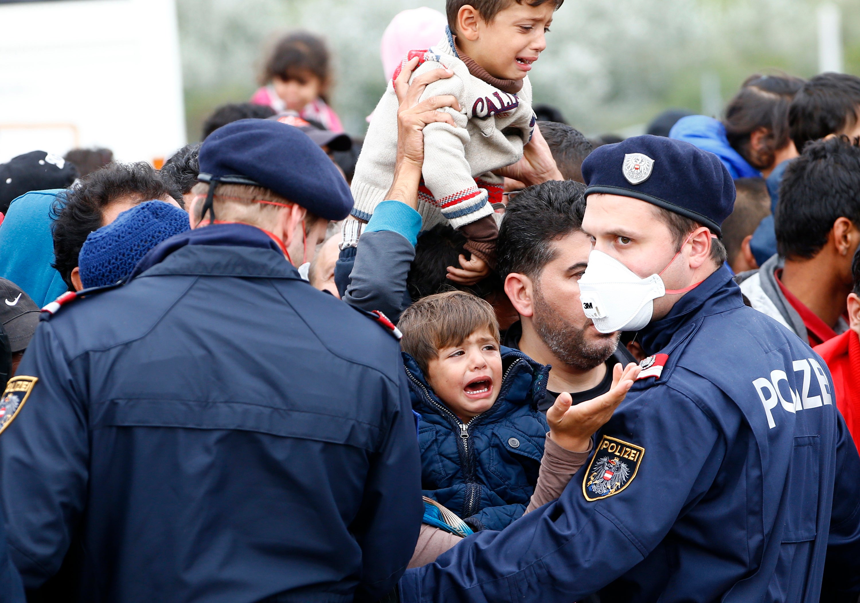 Police struggle to maintain order as refugees attempt to leave the border crossing in Nickelsdorf, Austria