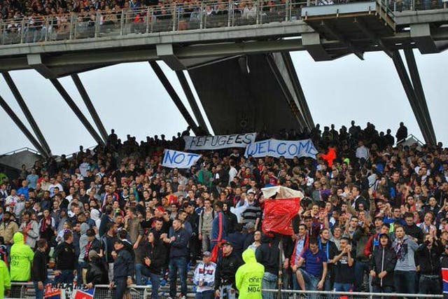 Lyon fans display 'refugees not welcome' banner