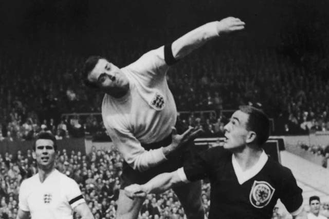Springett punches the ball clear of Scotland's Ian St John during England's 9-3 victory at Wembley in 1961