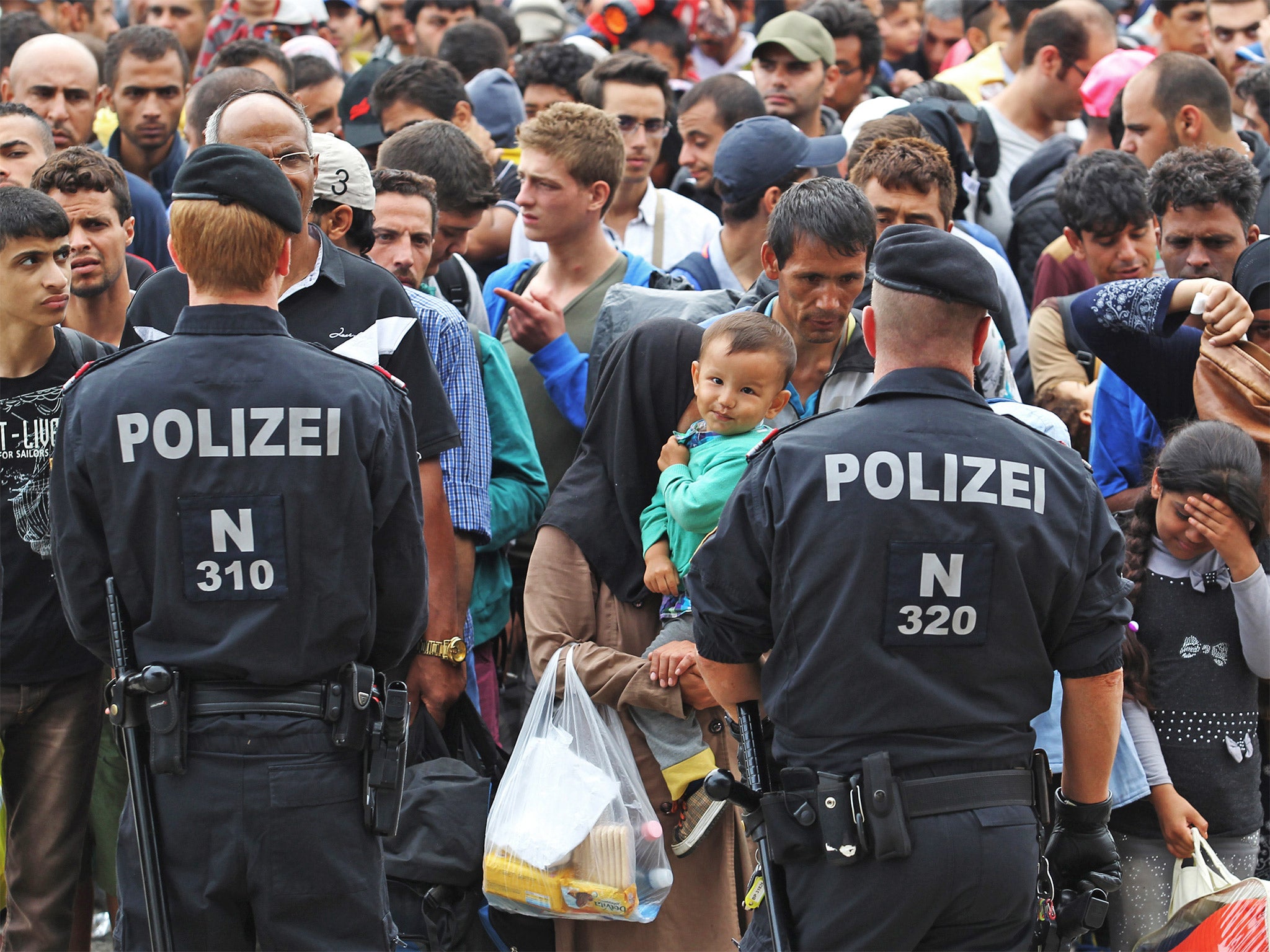 Refugees wait for buses to Vienna in Nickelsdorf, Austria