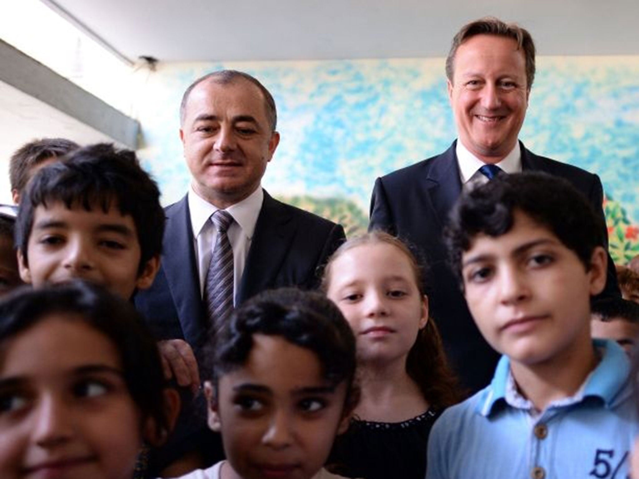 Lebanese Education Minister Elias Bou Saab stands beside Prime Minister David Cameron at the Sed El Boucrieh School in Beirut