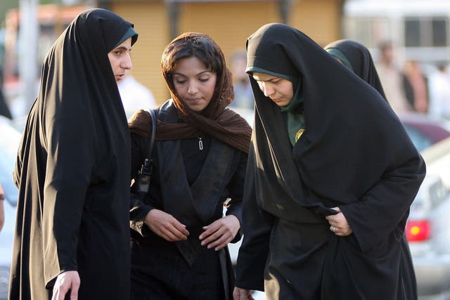 Rules on 'Islamic dress' for women are enforced by police in Iran. In this picture, two policewomen warn a woman (centre) about her hair and clothing during a crackdown on skirting of the law in 2007.