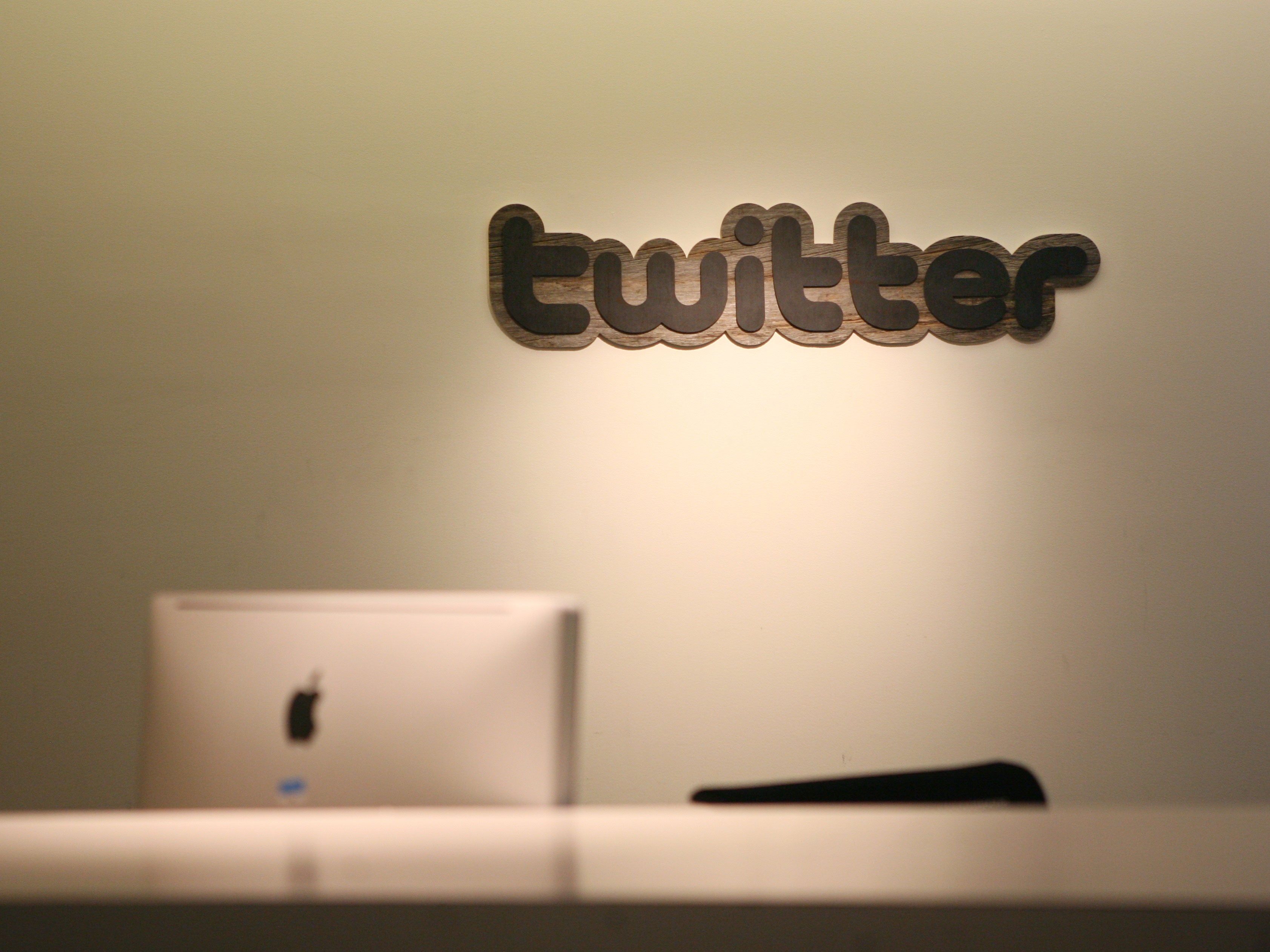 Twitter logo is displayed at the entrance of Twitter headquarters in San Francisco on March 11, 2011 in California