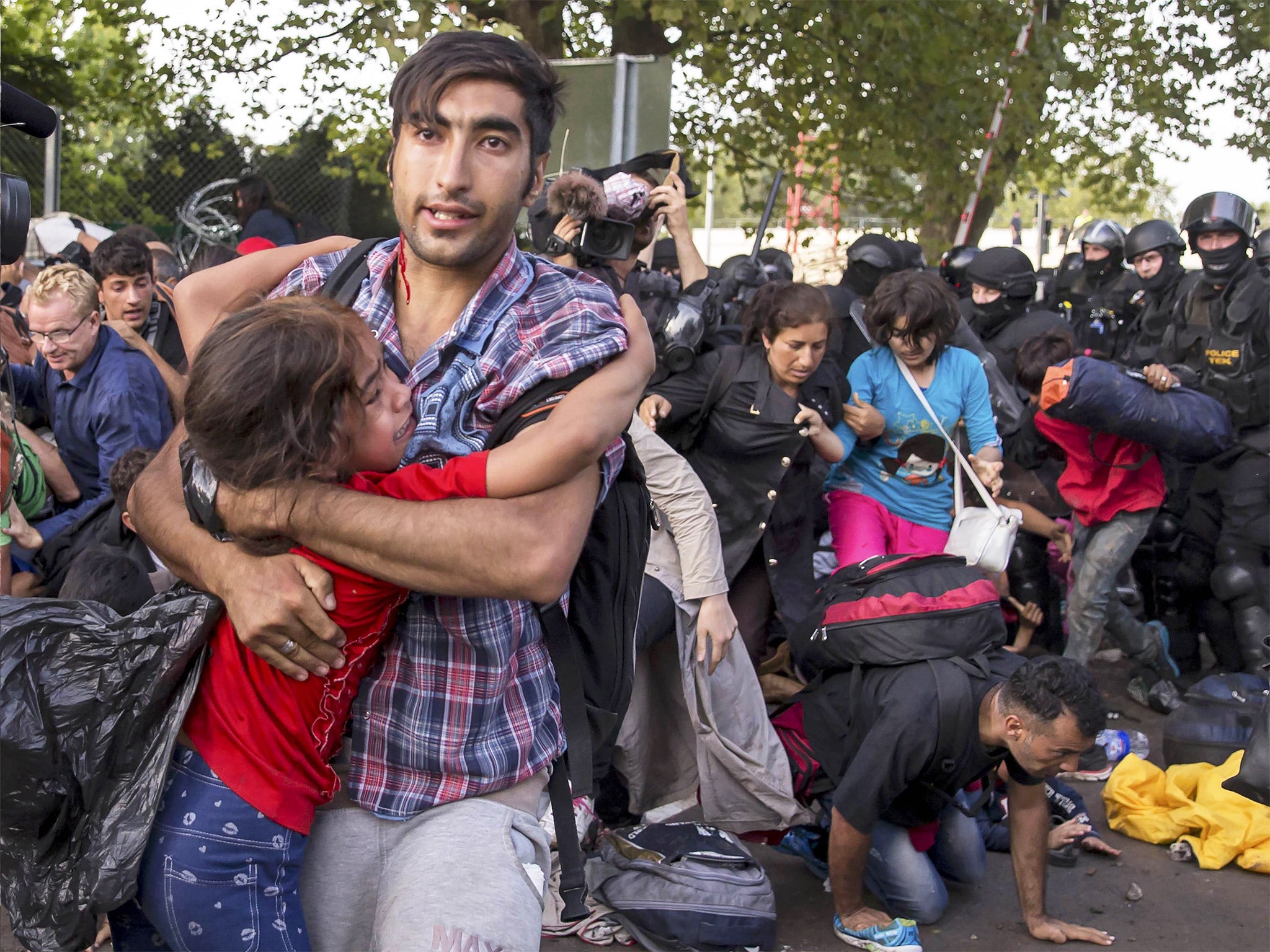 Violence erupts between Hungarian riot police and migrants at the border crossing with Serbia in Roszke, Hungary, on the second day of a border crackdown