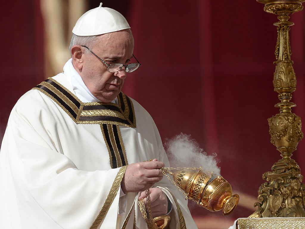 The Pope makes a blessing with incense