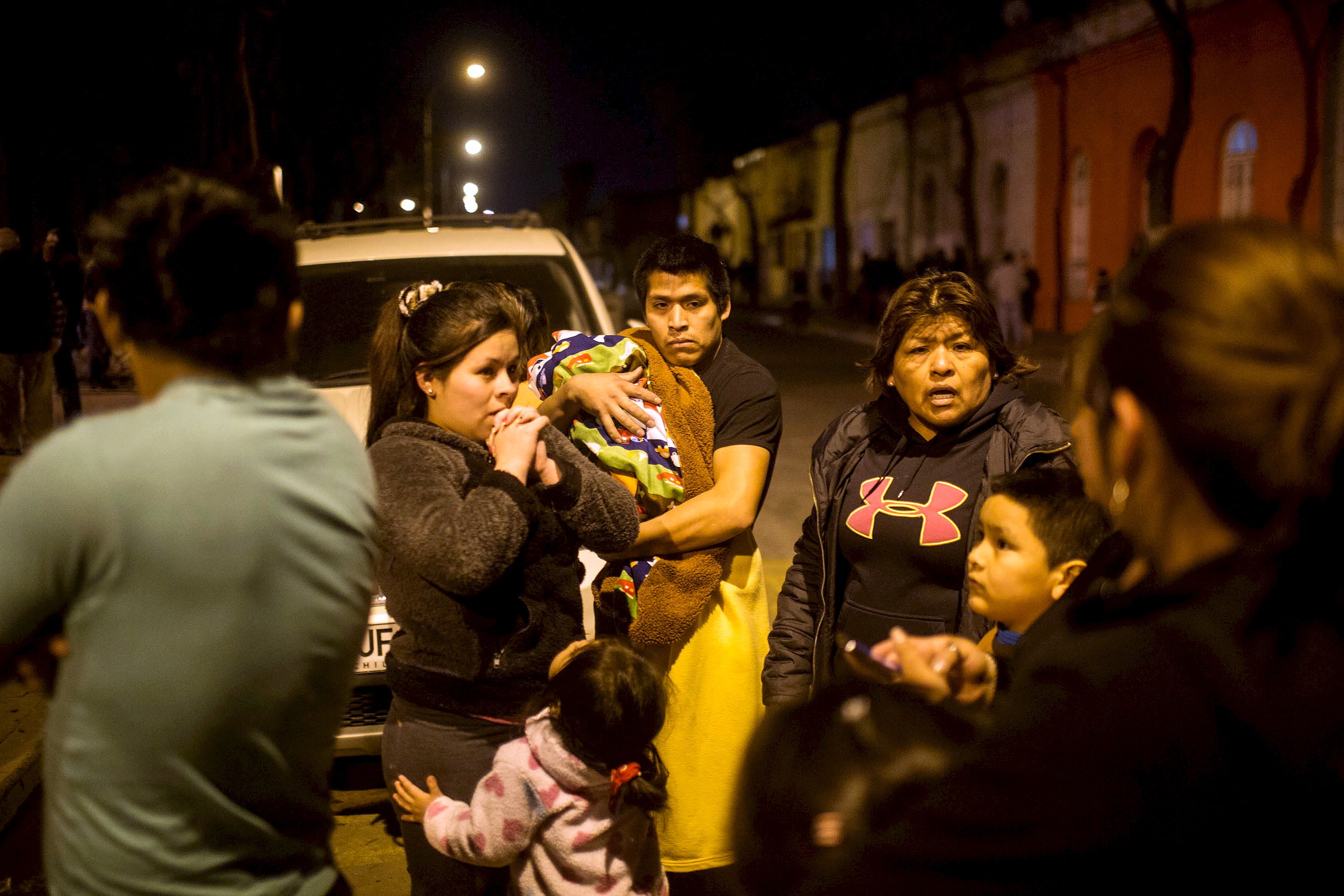 Residents leave their homes in Santiago
