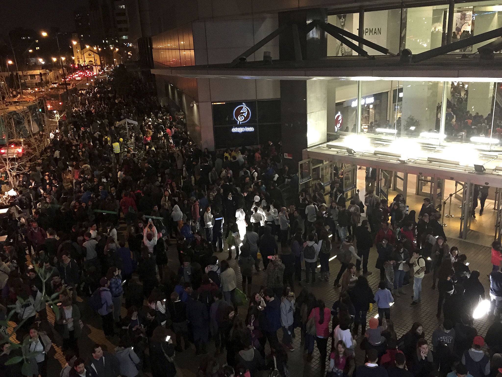 People evacuate a mall in Santiago after a powerful earthquake Sept. 16, 2015