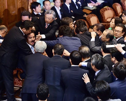 Japanese politicians fought over controversial proposals which critics say will lead to war