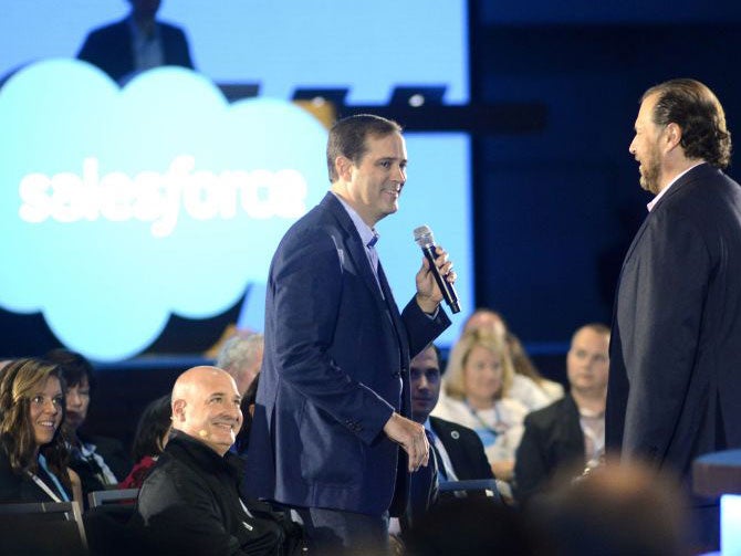 huck Robbins CEO of Cisco Sytems (L) and Marc Benioff speak at the Salesforce keynote during Dreamforce 2015