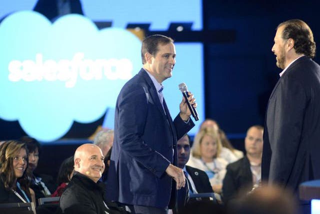 <p>Chuck Robbins CEO of Cisco Sytems (L) and Marc Benioff speak at the Salesforce keynote during Dreamforce 2015</p>