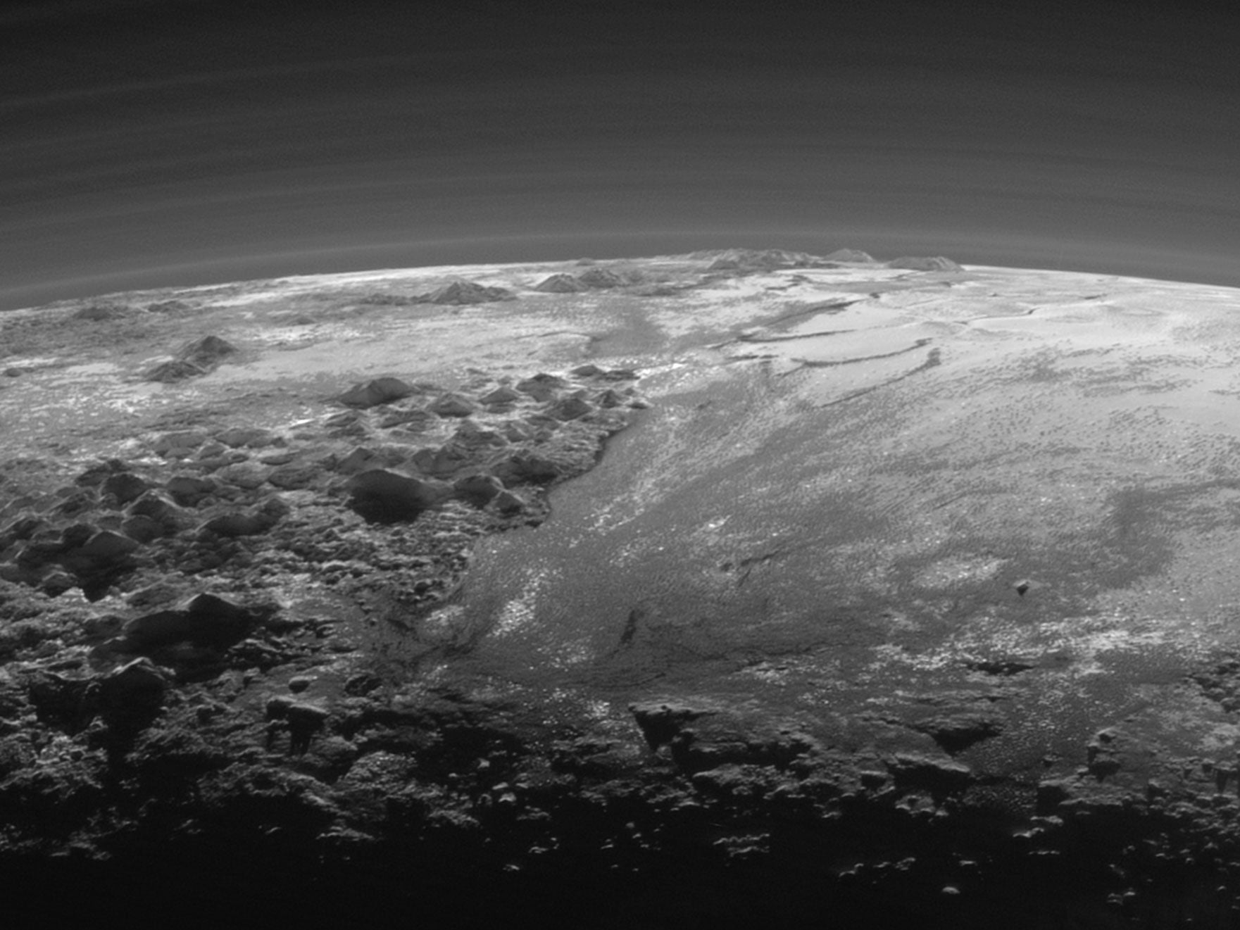 New Horizons took this image on its closest approach to Pluto on 14 July 2015, showing mountains and flat ice plains