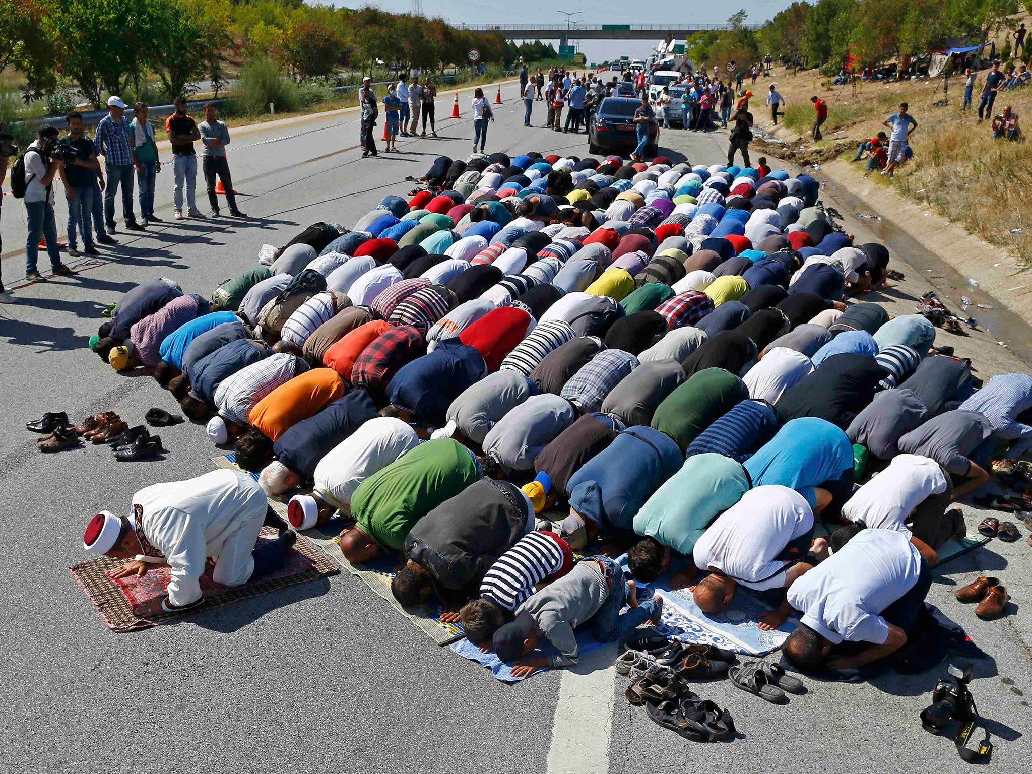 Refugees stop to pray near Edirne, Turkey, yesterday