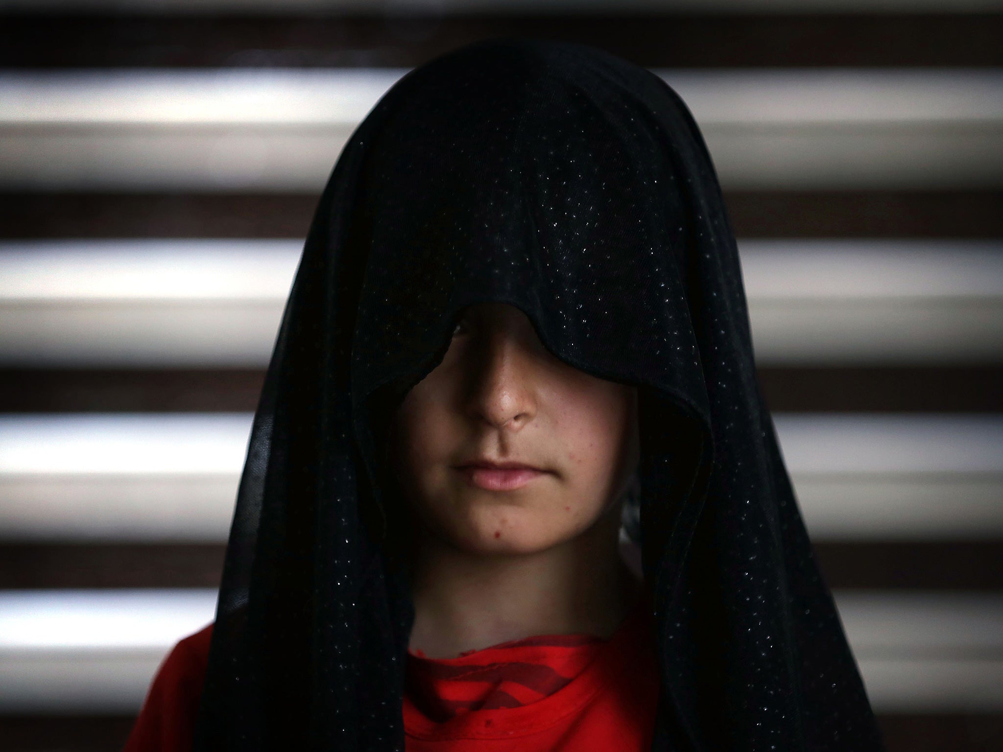A displaced Iraqi youth from the Yazidi community poses for a picture in the northern Iraqi town of Dohuk on May 20, 2015