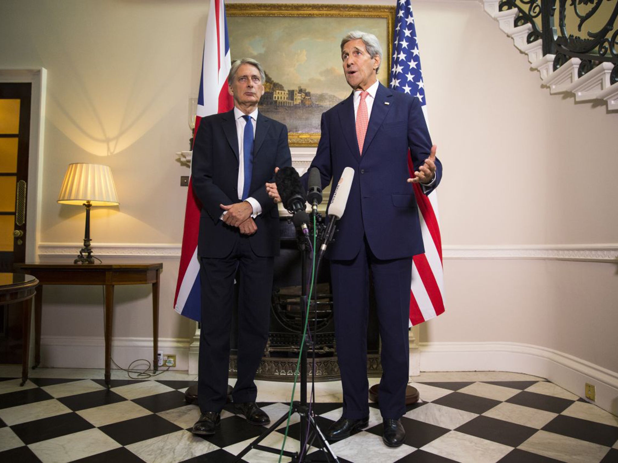 John Kerry, right, answers a question on Syria at a news conference with Philip Hammond in London on Saturday