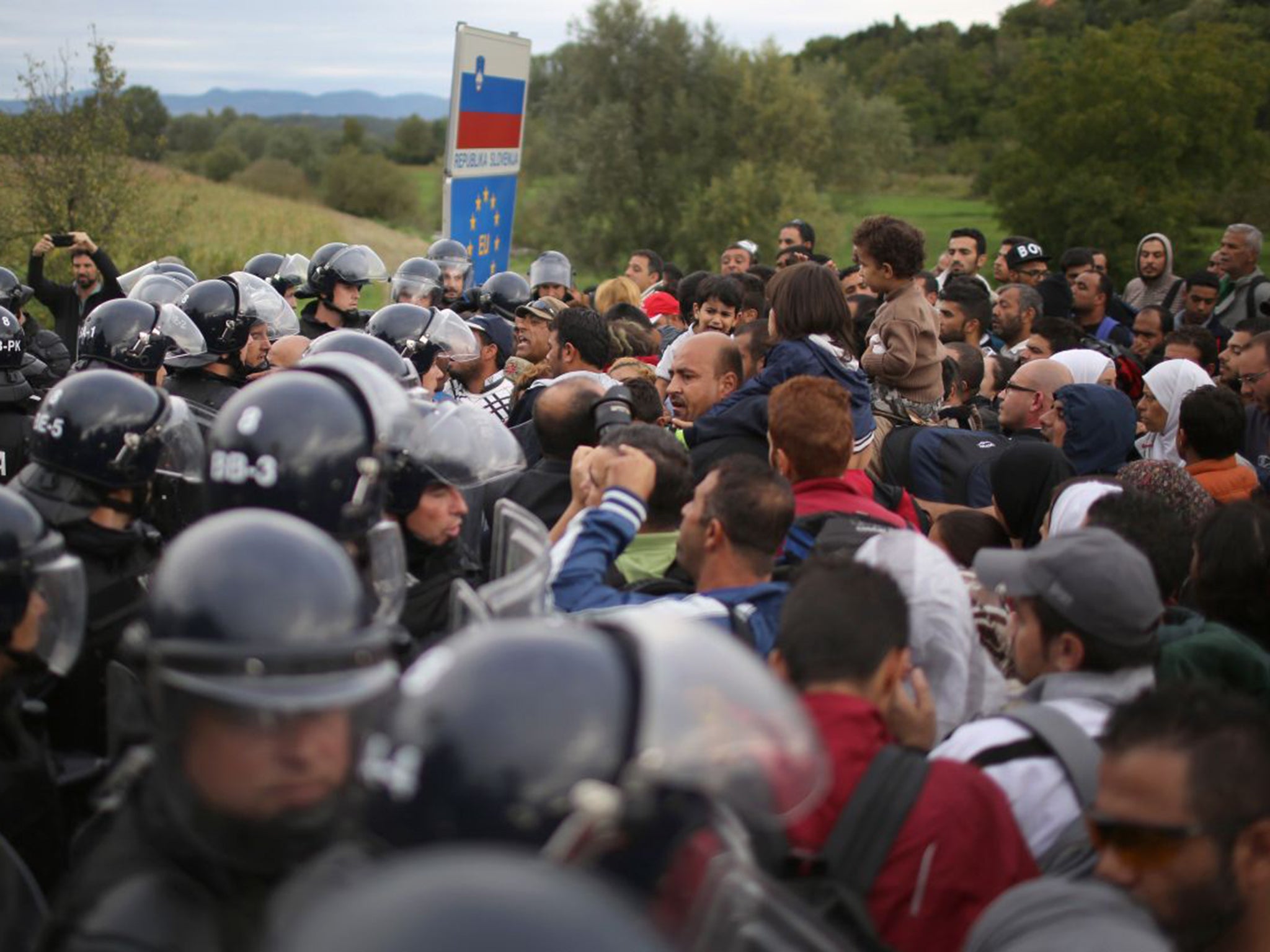 Refugees face police in Croatia where demonstrations turned ugly after some plastic bottles were thrown at the police, who responded by firing pepper spray into the crowd