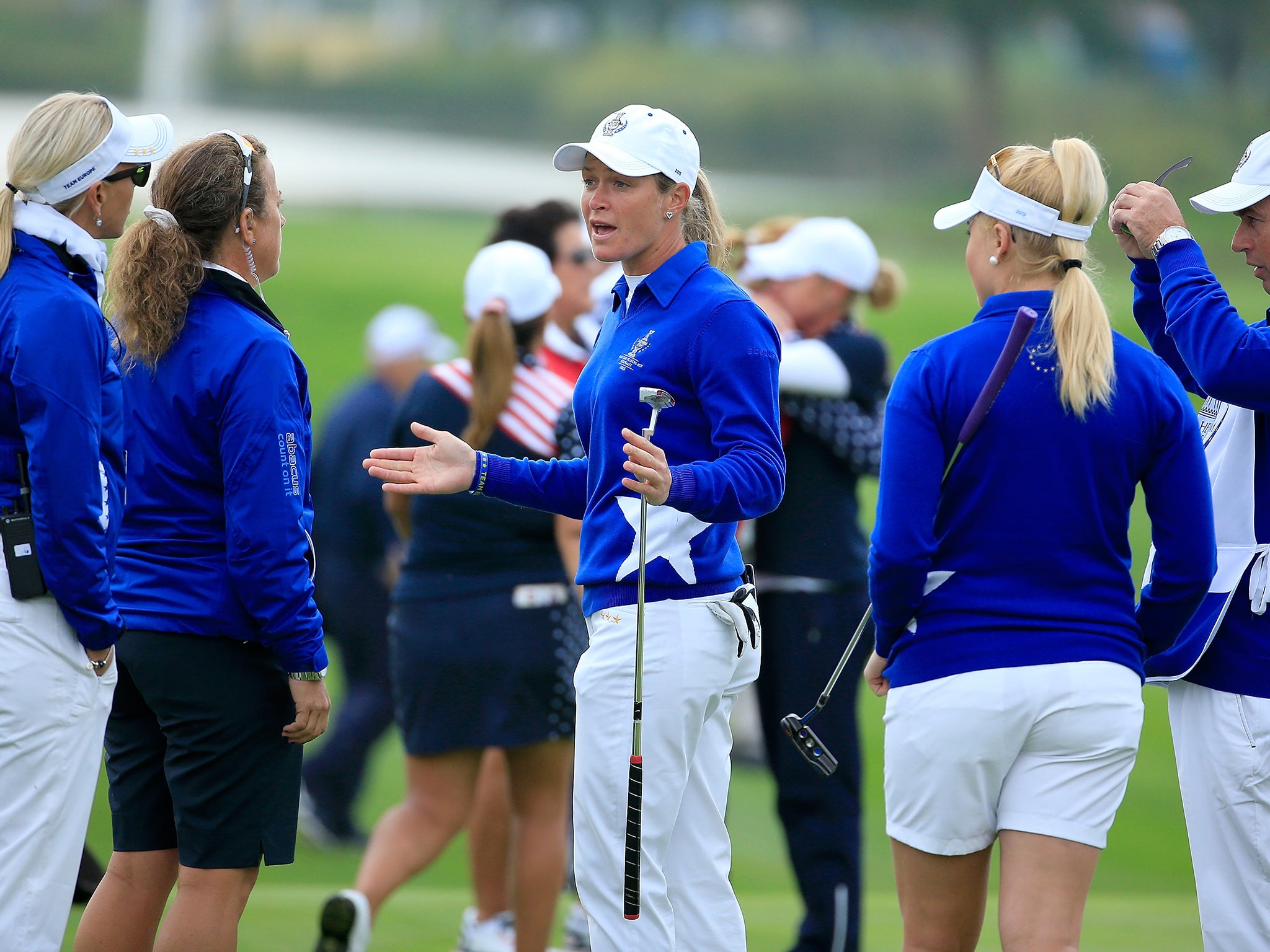Suzann Pettersen of the European team trying to explain to her captain Carin Koch the length of putt that she did not concede to Alison Lee