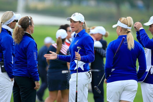 Suzann Pettersen of the European team trying to explain to her captain Carin Koch the length of putt that she did not concede to Alison Lee 
