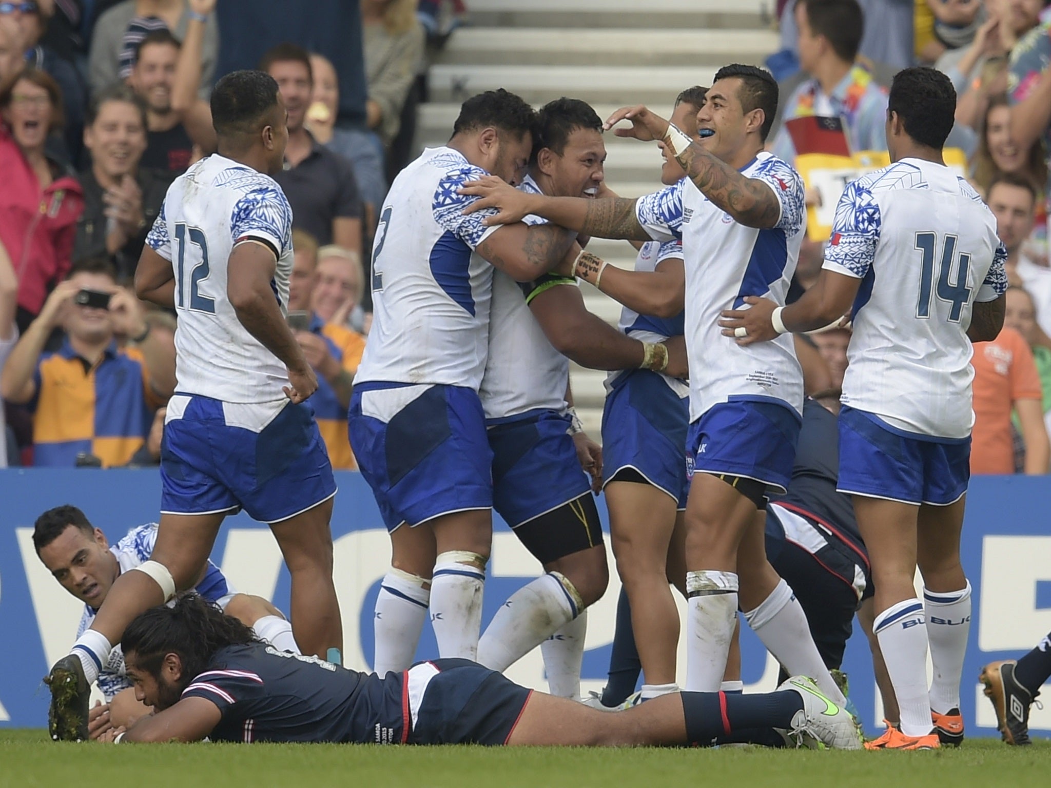 Samoa captain Ofisa Treviranus celebrates with his team-mates after scoring a try