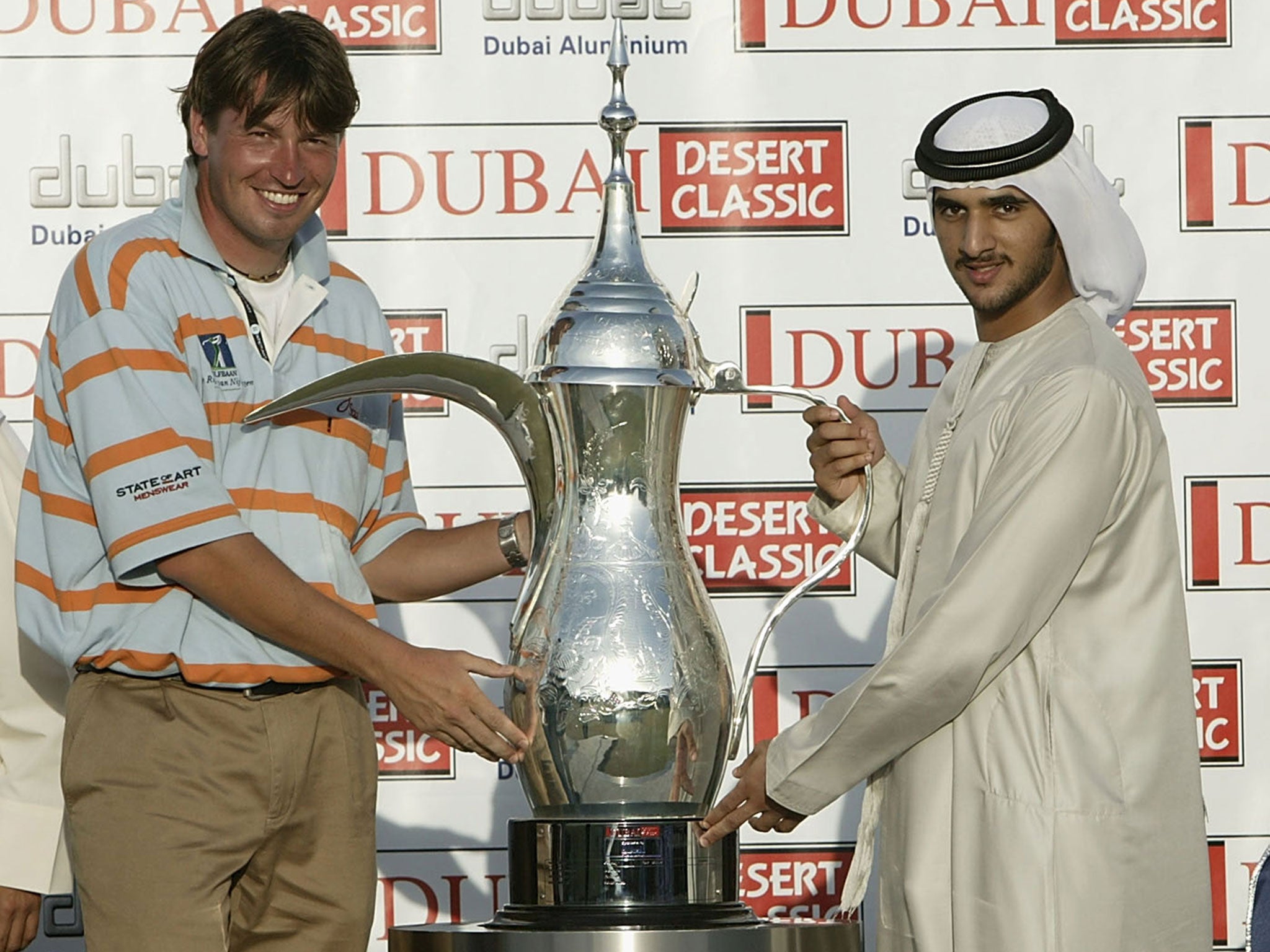 Golfer Robert-Jan Derkson receives a trophy from Sheikh Rashid in 2003