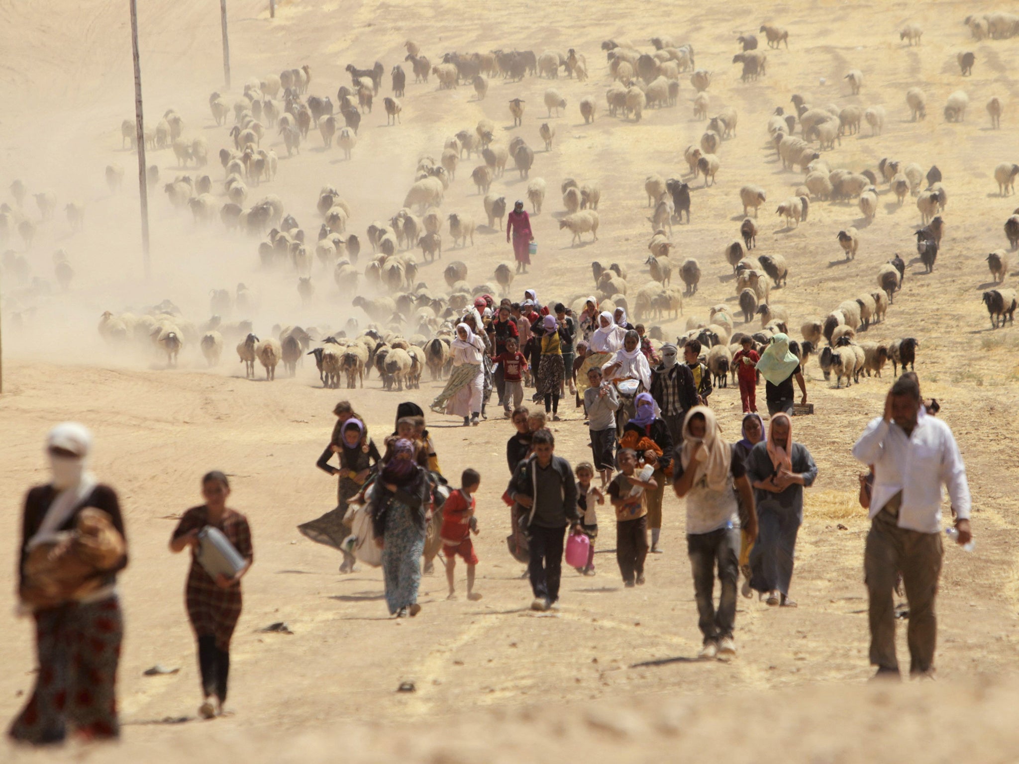 Displaced people from the minority Yazidi sect flee Isis in Al-Hasakah Governorate. Many Isis defectors said they were encouraged to leave by the group's brutality to innocent civilians.