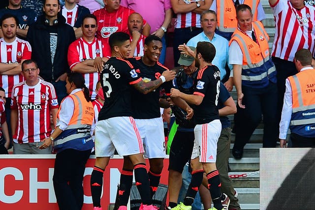 Anthony Martial is mobbed by team-mates
