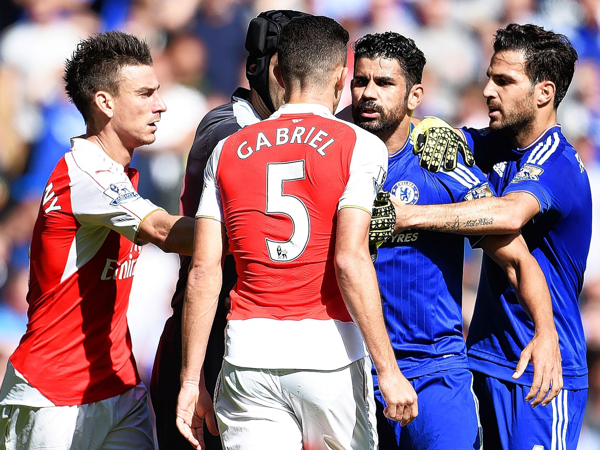 Chelsea striker Diego Costa (second right) squares up to Gabriel Paulista of Arsenal during Saturday’s match